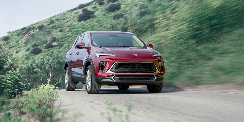 red buick encore on hilly road