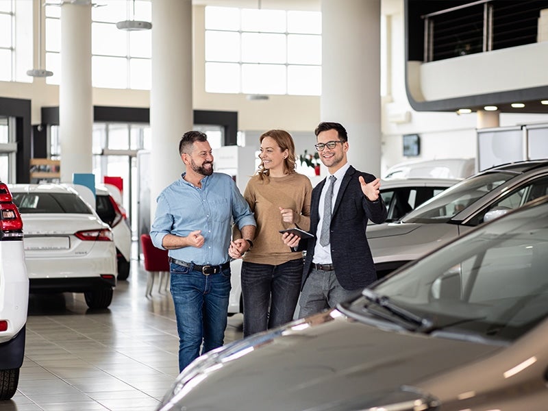 Mike Young Buick GMC sales team helping customers review vehicle options